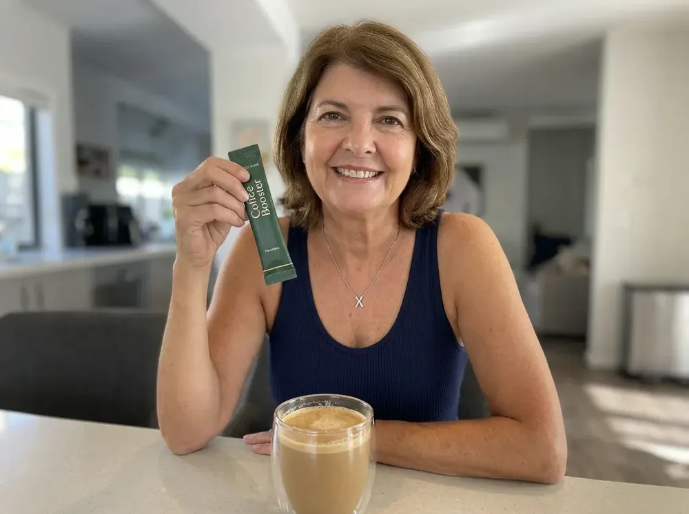 Happy customer holding a Coffee Boost sachet